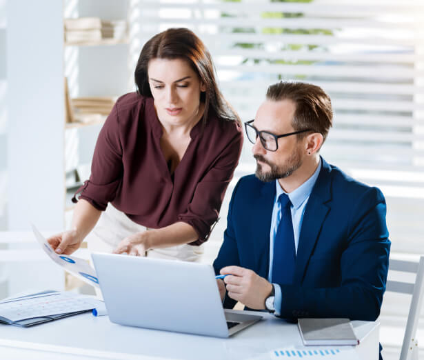 Two colleagues working together at a laptop